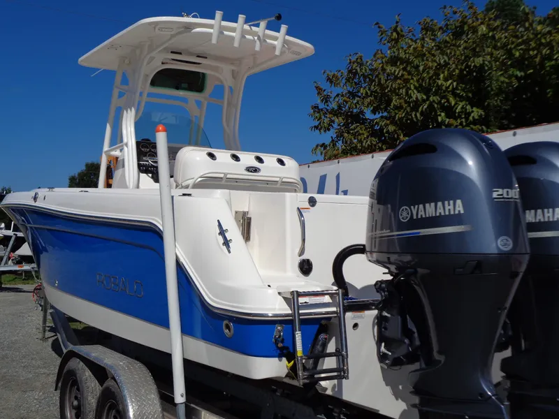 Slide: The Image of 2017 Robalo R260 Center Console boat with Yamaha engines on a trailer. - 21