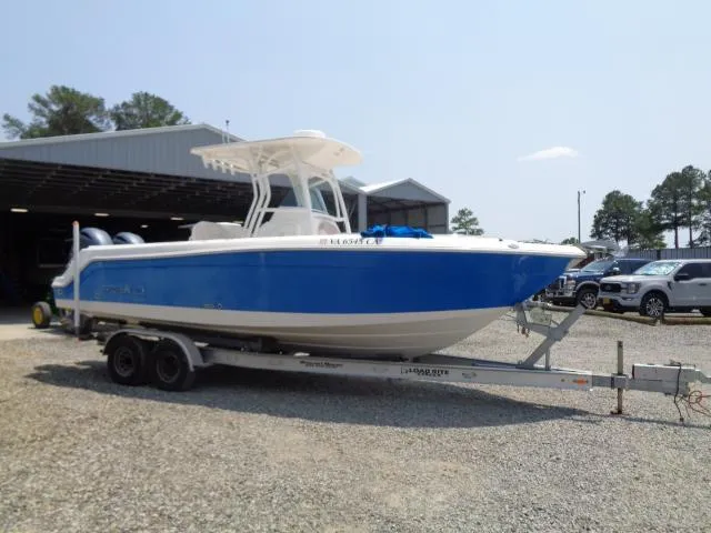 Slide: The Image of 2017 Robalo R260 Center Console boat on trailer, parked outdoors near a garage. - 27