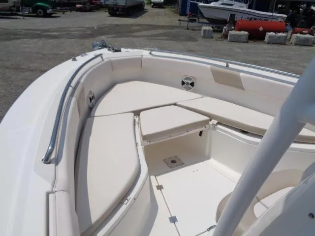 Slide: The Image of 2017 Robalo R260 Center Console boat interior with cushioned seating and storage compartments. - 30