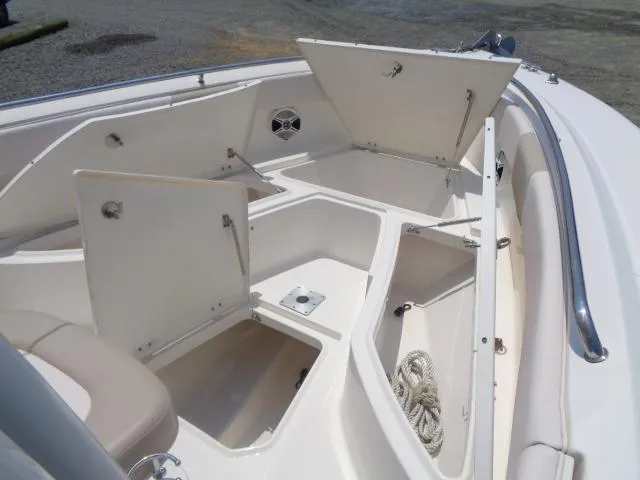 Slide: The Image of 2017 Robalo R260 Center Console boat with open storage compartments. - 32