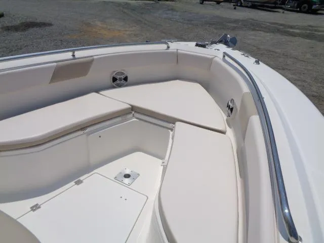 Slide: The Image of 2017 Robalo R260 Center Console boat interior with cushioned seating and storage. - 35