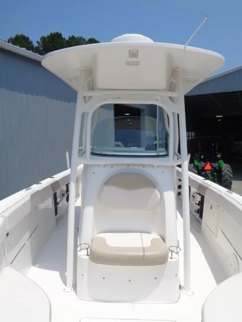 Slide: The Image of 2017 Robalo R260 Center Console boat with seating and T-top, docked outdoors. - 36