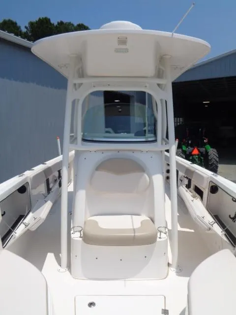 Slide: The Image of 2017 Robalo R260 Center Console boat with seating and T-top, docked outdoors. - 37