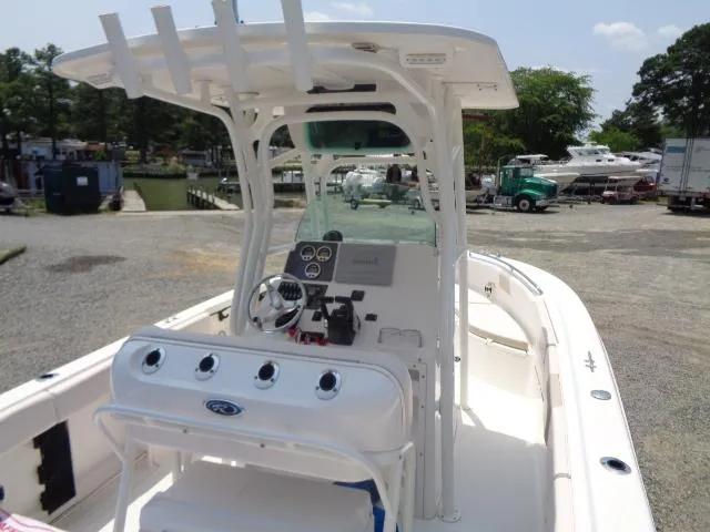 Slide: The Image of 2017 Robalo R260 Center Console boat with helm, rod holders, and spacious deck. - 41