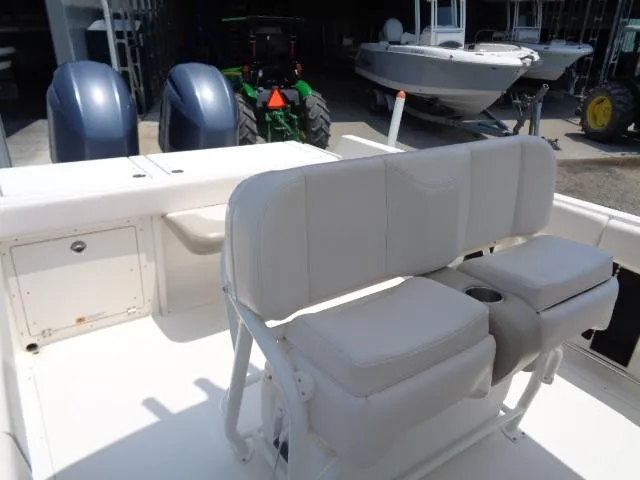 Slide: The Image of 2017 Robalo R260 Center Console boat interior with cushioned seating and dual outboard motors. - 42