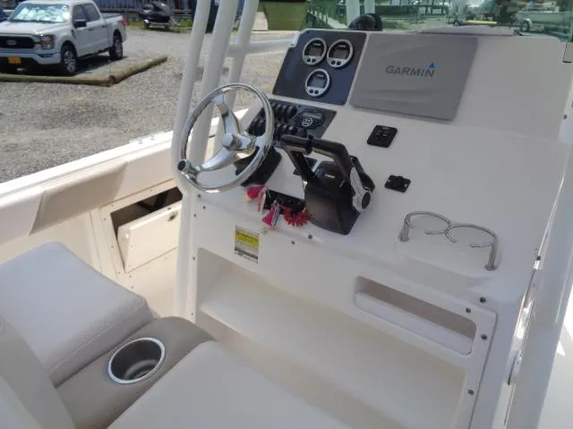 Slide: The Image of 2017 Robalo R260 Center Console boat dashboard with Garmin navigation system. - 43