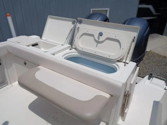 Slide: The Image of 2017 Robalo R260 Center Console boat with open storage compartments and cushioned seating. - 44