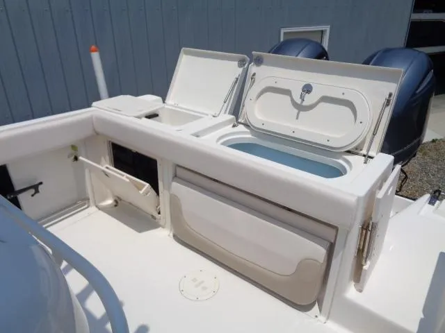 Slide: The Image of 2017 Robalo R260 Center Console boat with open storage compartments and dual engines. - 45