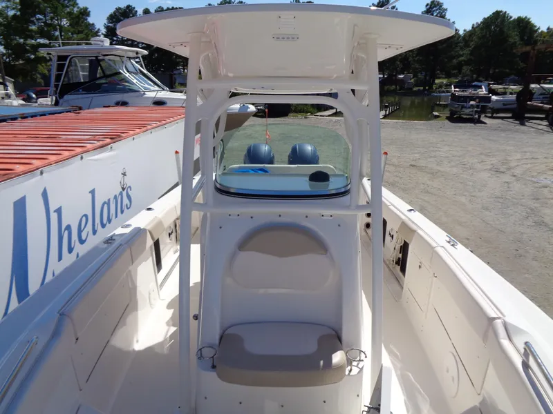 Slide: The Image of 2017 Robalo R260 Center Console boat with seating and console, docked near other boats. - 6
