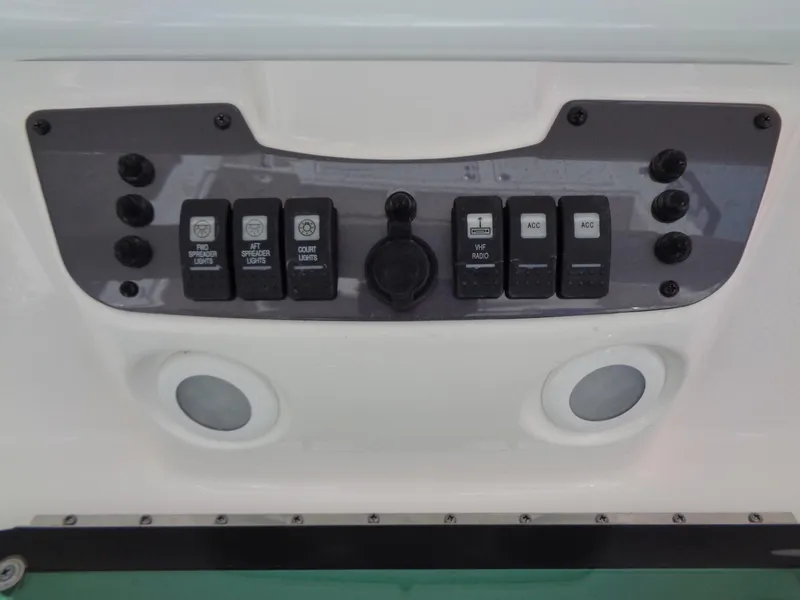 Slide: The Image of Control panel of a 2017 Robalo R260 Center Console boat with switches and dials. - 9