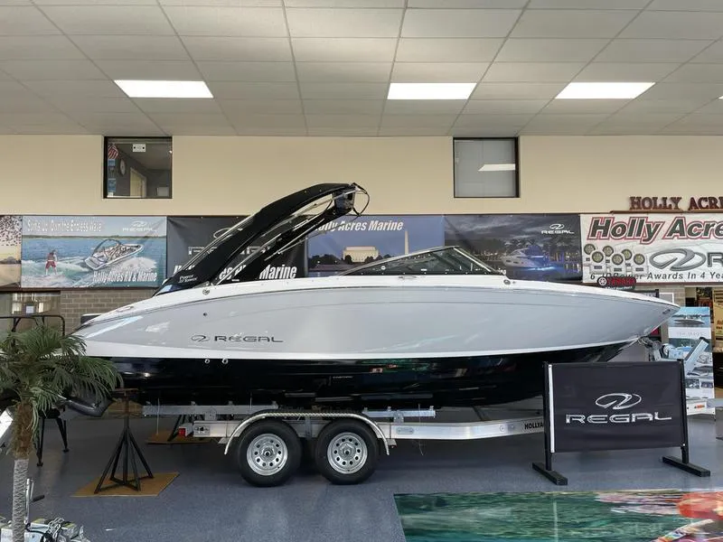 The Image of 2022 Regal LS6 boat displayed indoors on a trailer at Holly Acres Marine showroom. - 0