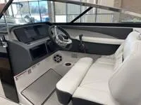 Slide: The Image of 2022 Regal LS6 boat interior with modern dashboard and white seating. - 3
