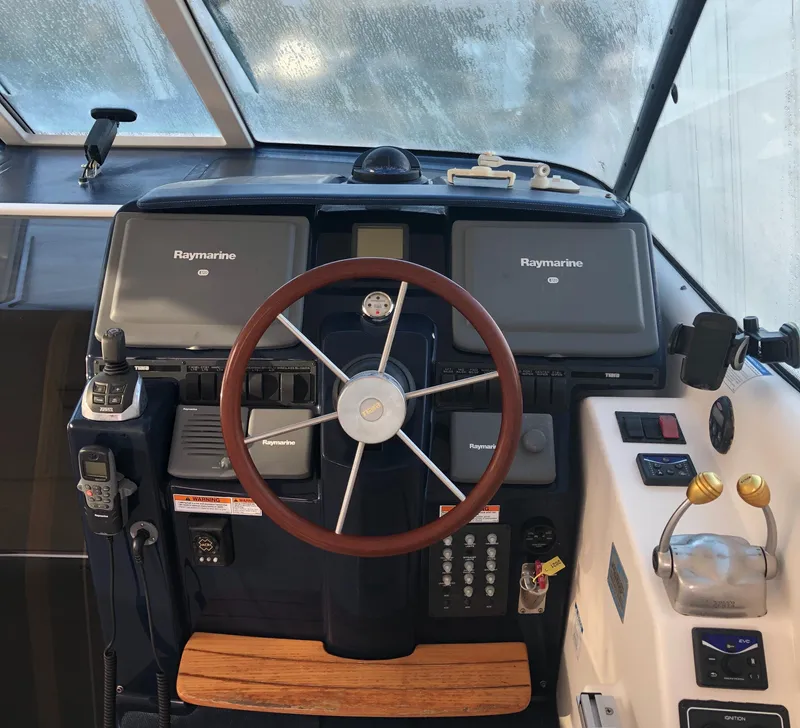Slide: The Image of 2008 Tiara Yachts 3900 Sovran helm with Raymarine electronics and wooden steering wheel. - 11