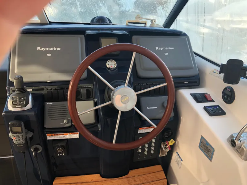 Slide: The Image of 2008 Tiara Yachts 3900 Sovran helm with Raymarine displays and wooden steering wheel. - 12