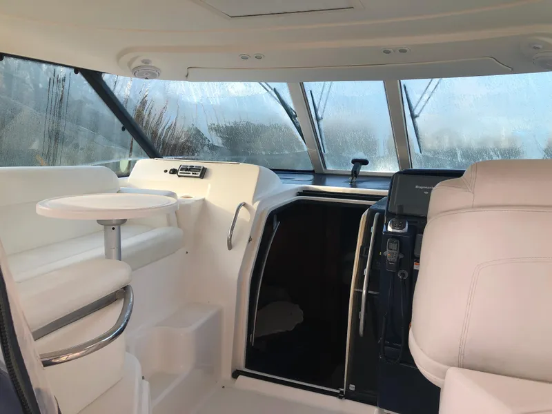 Slide: The Image of 2008 Tiara Yachts 3900 Sovran interior with helm, seating, and windows. - 19