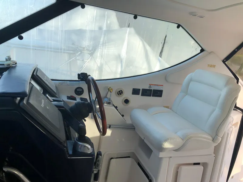 Slide: The Image of 2008 Tiara Yachts 3900 Sovran helm with leather seat and navigation controls. - 20
