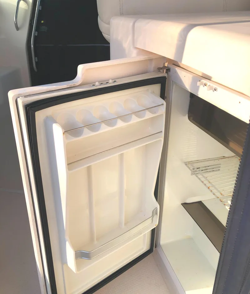 Slide: The Image of Open refrigerator on 2008 Tiara Yachts 3900 Sovran, showcasing interior storage space. - 25
