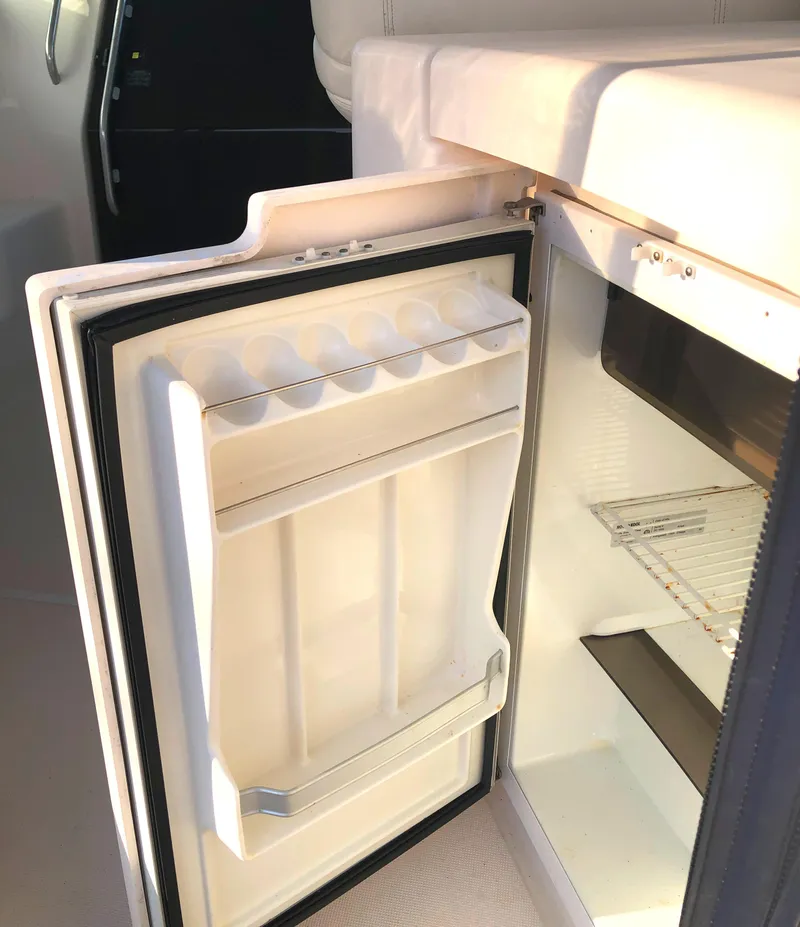 Slide: The Image of Open refrigerator on 2008 Tiara Yachts 3900 Sovran, showcasing interior storage space. - 32