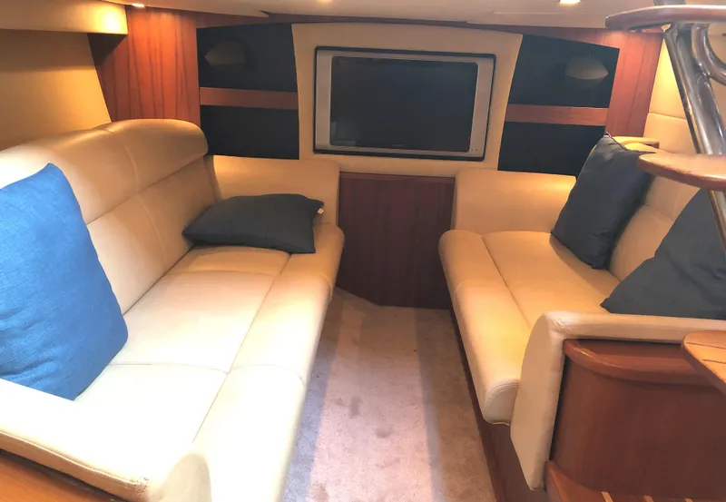 Slide: The Image of 2008 Tiara Yachts 3900 Sovran interior with beige seating and blue cushions. - 34
