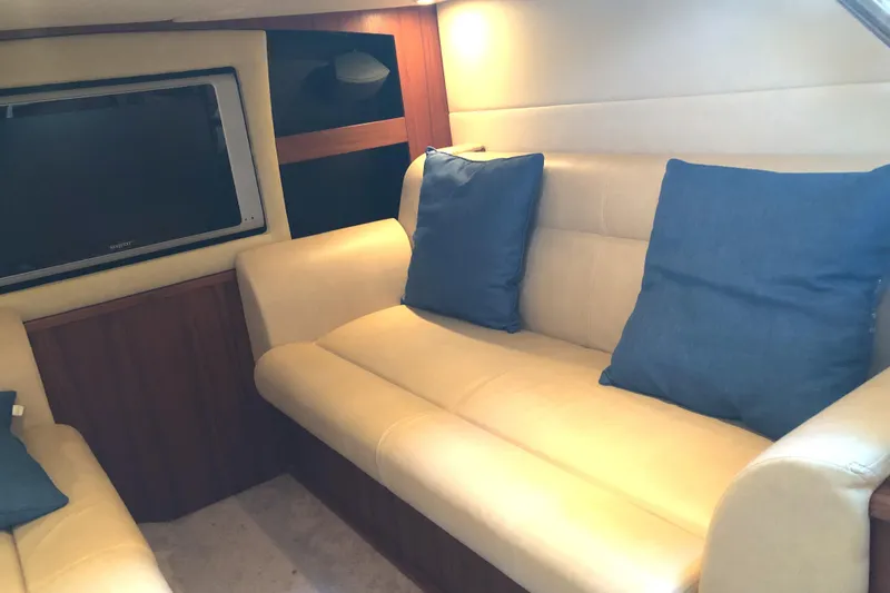 Slide: The Image of Interior of 2008 Tiara Yachts 3900 Sovran with beige seating and blue cushions. - 36