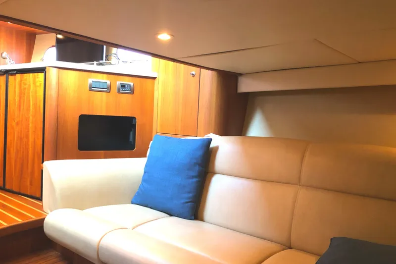 Slide: The Image of Interior of 2008 Tiara Yachts 3900 Sovran with beige seating and wooden cabinetry. - 37