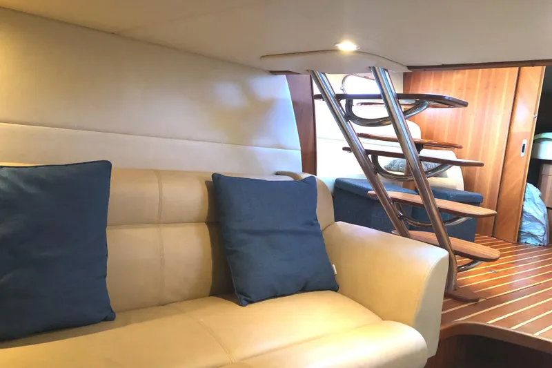 Slide: The Image of Interior of 2008 Tiara Yachts 3900 Sovran with beige seating and blue cushions. - 38