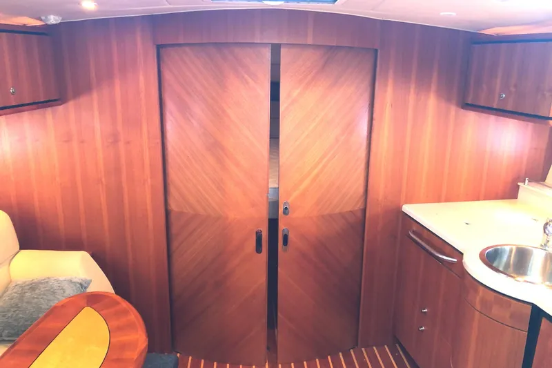 Slide: The Image of 2008 Tiara Yachts 3900 Sovran interior with wooden cabinetry and modern amenities. - 49