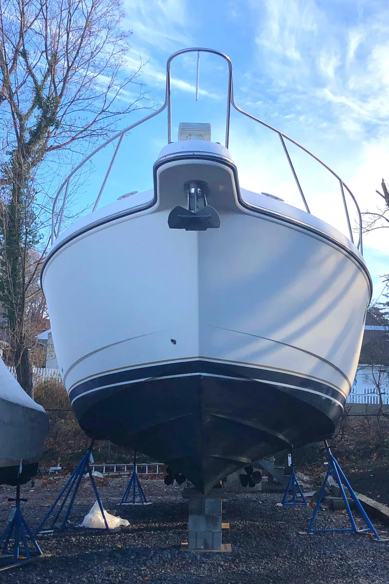 Slide: The Image of 2008 Tiara Yachts 3900 Sovran on stands, front view, under a clear blue sky. - 5