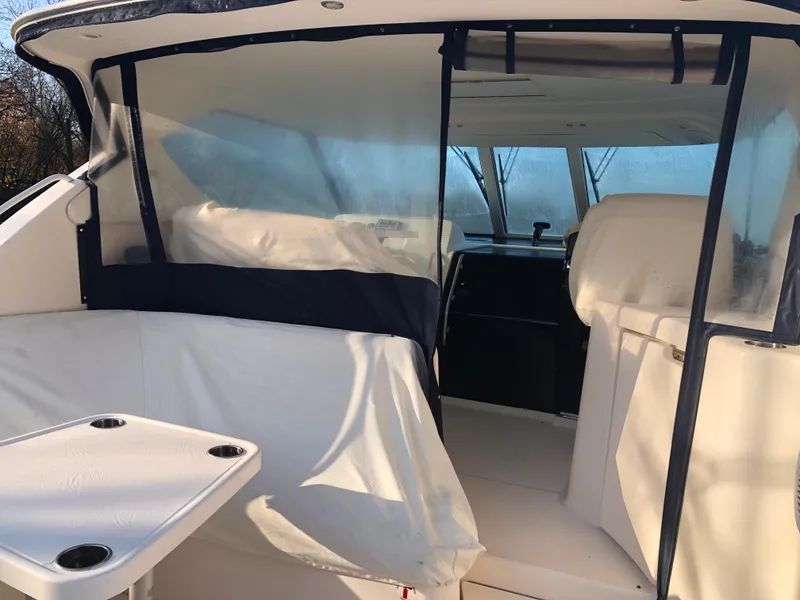Slide: The Image of 2008 Tiara Yachts 3900 Sovran interior with seating and table, featuring clear protective covers. - 9