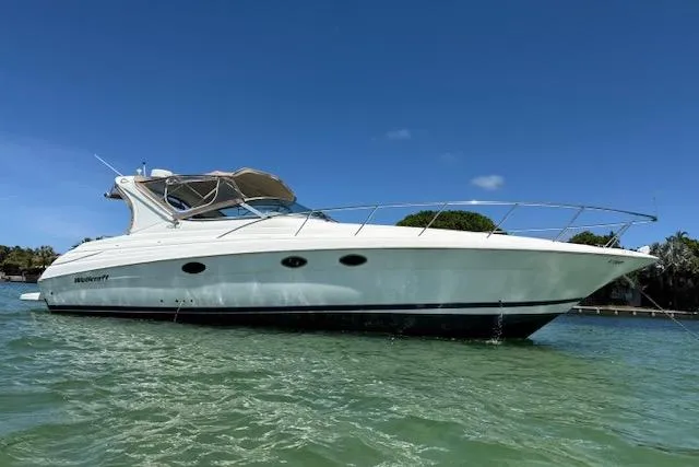 The Image of 2001 Wellcraft Martinique 3700 yacht on clear water under blue sky. - 0