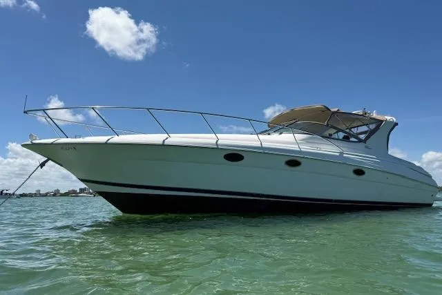Slide: The Image of 2001 Wellcraft Martinique 3700 yacht on clear water under blue sky. - 10