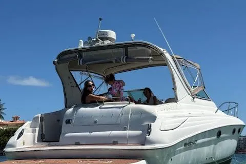 Slide: The Image of 2001 Wellcraft Martinique 3700 boat with people enjoying a sunny day on the water. - 11