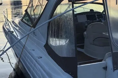 Slide: The Image of 2001 Wellcraft Martinique 3700 boat docked, featuring sleek design and covered cockpit. - 15