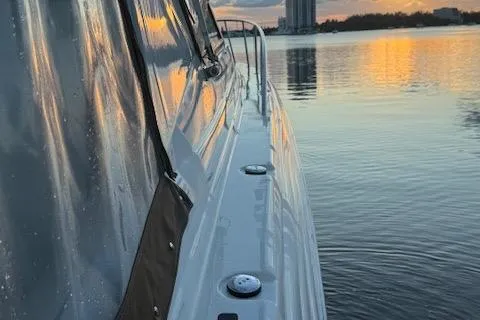 Slide: The Image of 2001 Wellcraft Martinique 3700 yacht on calm water at sunset, reflecting golden hues. - 18