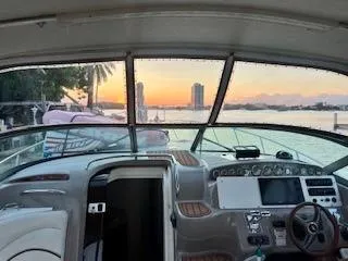 Slide: The Image of 2001 Wellcraft Martinique 3700 boat interior with sunset view through windshield. - 22