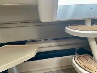 Slide: The Image of Interior view of 2001 Wellcraft Martinique 3700 boat with beige seating and wooden steps. - 23