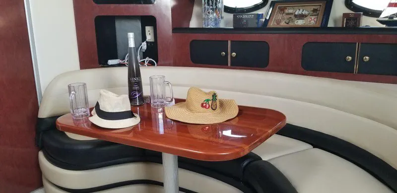 Slide: The Image of Interior of 2001 Wellcraft Martinique 3700 yacht with hats and drinks on table. - 24