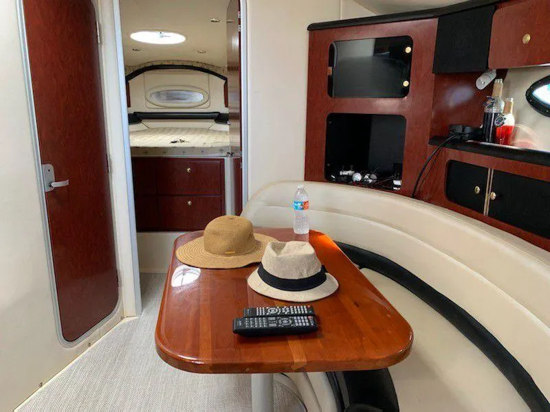 Slide: The Image of Interior of 2001 Wellcraft Martinique 3700 yacht with hats on table and cozy seating. - 25