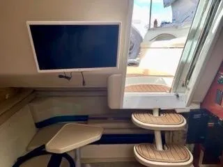 Slide: The Image of Interior of 2001 Wellcraft Martinique 3700 yacht with stairs and mounted TV. - 28