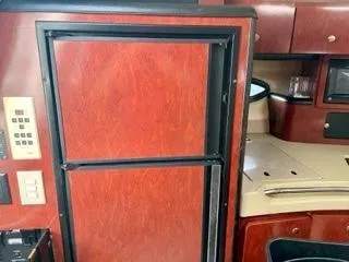 Slide: The Image of 2001 Wellcraft Martinique 3700 interior with wood cabinetry and built-in appliances. - 30