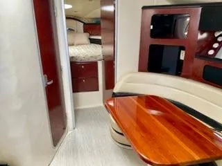 Slide: The Image of Interior of 2001 Wellcraft Martinique 3700 yacht with wood table and cozy seating area. - 32