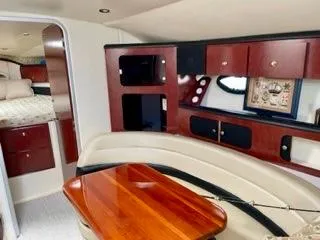 Slide: The Image of 2001 Wellcraft Martinique 3700 interior with wood accents and cozy seating area. - 33