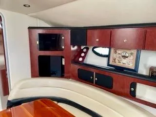 Slide: The Image of 2001 Wellcraft Martinique 3700 interior with wood cabinetry and beige seating. - 34