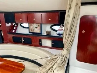 Slide: The Image of Interior of 2001 Wellcraft Martinique 3700 yacht with wood cabinets and nautical decor. - 35