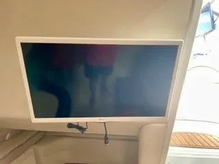 Slide: The Image of Wall-mounted TV inside 2001 Wellcraft Martinique 3700 yacht cabin. - 36