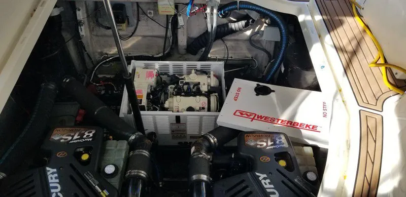 Slide: The Image of Engine compartment of 2001 Wellcraft Martinique 3700 with Westerbeke generator and Mercury engines. - 38