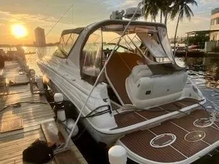 Slide: The Image of 2001 Wellcraft Martinique 3700 boat docked at sunset with palm trees in the background. - 4