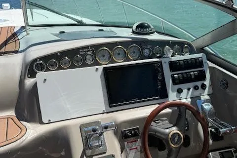 Slide: The Image of 2001 Wellcraft Martinique 3700 boat dashboard with gauges and steering wheel. - 42