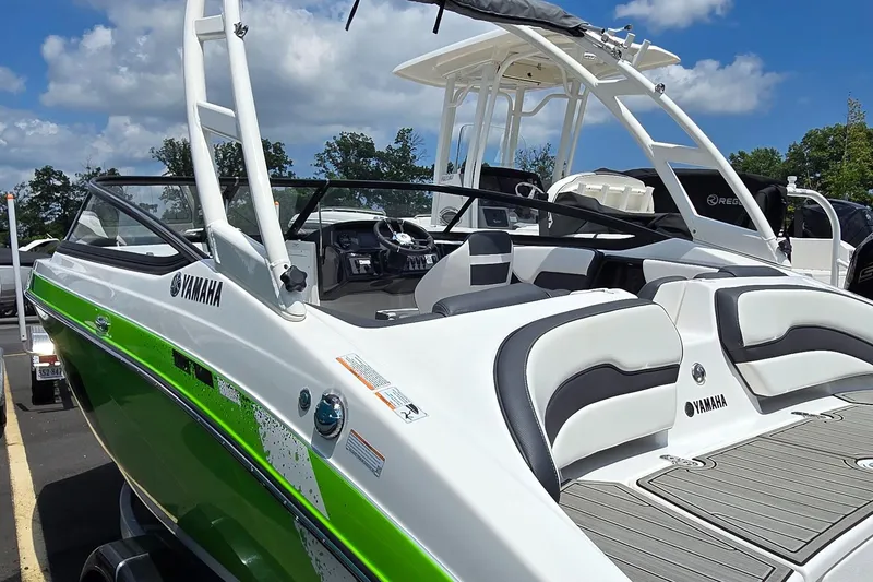 Slide: The Image of 2022 Yamaha AR195 boat with green accents, sleek design, and spacious seating. - 3