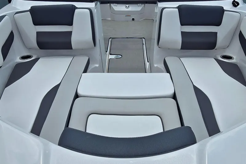 Slide: The Image of 2022 Yamaha Boats AR195 interior seating with gray and white upholstery. - 7